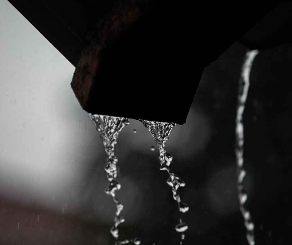 Rain flowing from a gutter spout